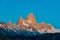 Low-angle of ridged snowy mountain at sunset against clear sky