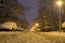 Low angle of rows of parked cars at night, covered with snow, on a narrow street, after a heavy snowfall in Winter time