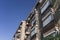 Low angle shot of a brick apartment building with laundry hanging from balconies