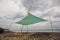 A low angle shot of a canopy tent on the beach