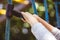 Low angle shot of a child holding on to a blue climbing toy on the playground of a park