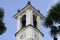 Low angle shot of a church tower with bells and palm leaves in Ticino, Switzerland