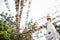 Low angle shot of colorful festive flags hung on wires with green trees in the background