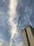 Low angle shot of the facade of the tall building under a scenic sky