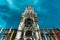 Low angle shot of the facade of the town hall of Marienplatz in Munich Germany against a blue sky