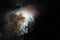 Low angle shot of fireworks behind the cloud with a dark background