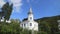 Low angle shot of a historic steeple building surrounded by green trees in the City Sinaia, Romania