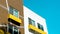 Low angle shot of modern concrete brown and white buildings with yellow balconies