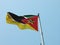 Low angle shot of Mozambique flag blowing in the wind in the capital city of Maputo