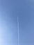 Low angle shot of a plane track on a clear blue sky on a sunny day