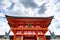 Low angle shot of the Romon gate against a cloudy sky at Fushimi Inari Taisha in Kyoto Japan