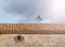 Low angle shot of roof tile on dark cloudy sky background in Soria, Spain