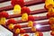 Low angle shot of a series of Chinese red lanterns hanging from red pieces of wood