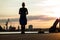 Low angle shot silhouette of woman in blue dress standing on pier