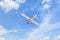 Low angle shot of a Single engine ultralight plane flying in the blue sky with white clouds