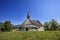 Low angle shot of a small church in the countryside in Slovenia under the bright sky