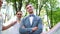 Low angle shot of smiling groom standing still and brides walking around him