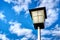 Low angle shot of a streetlamp against a cloudy blue sky