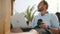 Low angle shot of successful happy comfortable freelancer man with laptop and drink resting in beach lounge resort chair