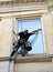 Low angle shot of suspended window cleaners working on a building