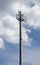 Low angle shot of a tall cell tower under a cloudy sky