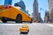 Low angle shot of a taxi toy car on the streets of Manhattan, New York, USA