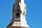 Low angle shot of a white historic clocktower on a blue background