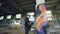 Low angle shot of young man is face mask painting graffiti on column inside empty industrial building using spray paint