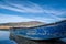 Low angle small blue abandoned fishing boat