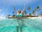 LOW ANGLE: Smiling young woman splashing glassy ocean water with her hands.