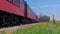 Low Angle of a Steam Passenger Train With Smoke and Steam Passing on a Windy Summer Day