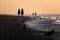 Low angle of three silhouettes riding horses on the beach at sunset in Nieuwpoort, Belgium