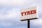 Low Angle Tyres Logo Sign over cloudy sky