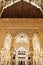 Low angle of the uniquely carved arch walls of the Alhambra Palace in Granada, Spain