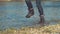 LOW ANGLE: Unrecognizable girl in boots enjoying the autumn by running outdoors