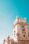 Low-angle vertical of Belem tower fortification clear sunlit sky background