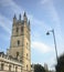 Low angle vertical shot of a building in Oxford, England with a cloudy blue sky in the background