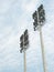 Low angle vertical shot of posted stadium lights