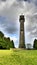 Low angle vertical shot of the Somerset Monument against a cloudy sky in Hawkesbury, Gloucestershire