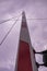 Low angle vertical shot of a striped pole under a rainy cloudscape