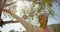 Low angle view of active African American senior woman performing yoga in the garden of nursing home