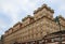 Low angle view of the Adria Palace under a cloudy sky in Prague in Czechia