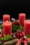 Low angle view of beautiful advent wreath with one burning candle on black background