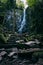 Low angle view of Burgbach Wasserfall with rocky cascade in Germany