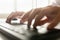 Low angle view of a businessman typing on a computer keyboard