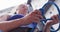 Low angle view of caucasian woman knotting rope in a harness belt at indoor climbing wall