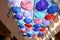 Low Angle View Of Colorful Umbrellas Hanging Outdoors.The ceiling in the store is decorated with rainbow umbrellas to attract