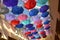 Low Angle View Of Colorful Umbrellas Hanging Outdoors.The ceiling in the store is decorated with rainbow umbrellas to attract