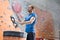 Low angle view of confident man dusting powder by climbing wall in crossfit gym