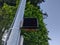 Low angle view of a crosswalk signal on a grey pole